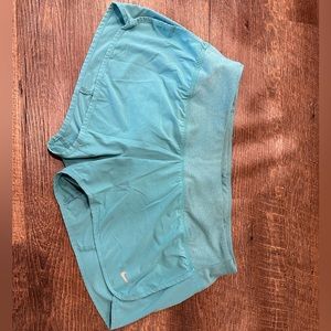 Teal Nike running shorts with the built in liner